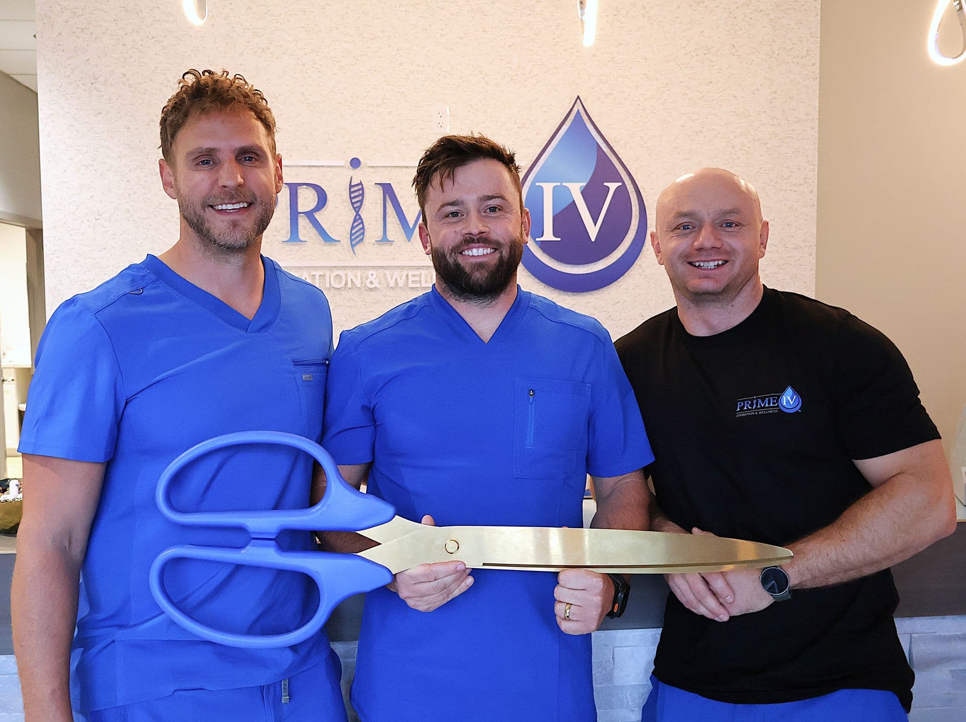 The Prime IV Coeur d'Alene team celebrating their grand opening with a ribbon-cutting